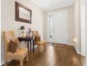 Inviting foyer featuring hardwood floors, decorative seating, and a front door with decorative glass at 337 Meadow Pointe Dr, Haines City, FL 33844