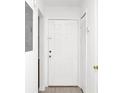 Bright entryway featuring tile floors, white walls, and a white front door at 4403 S Semoran Blvd # 3, Orlando, FL 32822