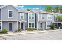 Inviting two-story townhome showcases a manicured lawn, with a convenient parking area at 4443 Brook Hollow Cir # 19A, Winter Springs, FL 32708