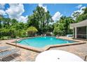 Community pool featuring brick pavers, multiple chairs and tables for relaxing in the sun at 4443 Brook Hollow Cir # 19A, Winter Springs, FL 32708