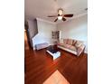 Comfortable living room boasts hardwood floors, modern furniture, and natural light at 6013 Scotchwood Gln # 20, Orlando, FL 32822