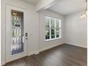 Bright entryway boasts a decorative glass door, new floors, and abundant natural light through a large window at 7816 Winter Wren St, Winter Garden, FL 34787