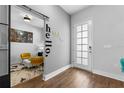 Stylish entryway with modern decor, including a 'hello' wall decal, and wood-look flooring at 8427 Modiano St, Orlando, FL 32827