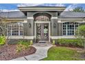 Stunning front entrance with double doors, decorative glass, and inviting walkway at 2508 Fawn Run, Oviedo, FL 32765