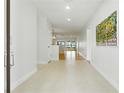 Bright hallway with tile transitioning to wood flooring, leading to a living space with expansive water views at 10209 Trout Rd, Orlando, FL 32836