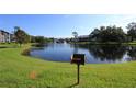 Scenic pond with a fountain, surrounded by trees and green grass with grill at 1131 S Pine Ridge Cir # 1, Sanford, FL 32773