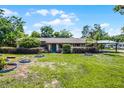 Well-maintained home with lush green lawn, covered carport, and inviting facade at 1250 Tangerine Ct, Eustis, FL 32726