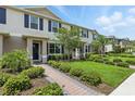 Beautiful townhome showcasing well-maintained landscaping, a brick walkway, and inviting curb appeal at 13293 Pontoon Rd, Winter Garden, FL 34787