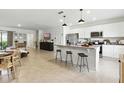 Spacious kitchen with granite counters, a center island with barstool seating, and stainless steel appliances at 13293 Pontoon Rd, Winter Garden, FL 34787