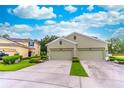 Lovely home showcasing a three-car garage and lush landscaping on a sunny day at 1356 Scarlet Oak Loop, Winter Garden, FL 34787