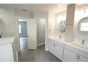 Bright bathroom featuring double sinks and white cabinets at 14308 Abington Heights Dr, Orlando, FL 32828