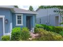 Charming single-story home with a brick walkway, lush landscaping, and a welcoming blue exterior at 1529 Chelsea Manor Cir, Deland, FL 32724