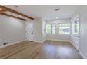 Bright living room featuring exposed beams, lots of light, and luxury vinyl flooring at 1801 Palm Ln, Orlando, FL 32803