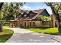 Brick home featuring dormer windows, long driveway, and manicured front lawn at 1815 Big Oak Ln, Kissimmee, FL 34746