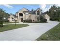 Elegant home featuring a large circular driveway, manicured lawn, and tasteful landscaping at 1865 S Tanner Ct, Deltona, FL 32738
