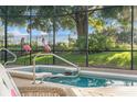 The outdoor jacuzzi has a screen around it with two flamingo statues adding a tropical touch at 1962 Flora Pass Pl, Kissimmee, FL 34747