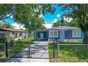 Charming blue home with a fenced yard and a convenient carport at 207 Kay St, Auburndale, FL 33823