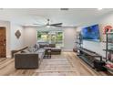 Bright living room featuring hard surface floors, large window, and comfortable seating at 209 Carriage Hill Dr, Casselberry, FL 32707