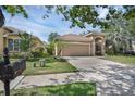 Charming single-story home boasts a manicured lawn, arched entryway, and attached two-car garage at 215 Foxglove Way, Deland, FL 32724