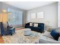Cozy living room with modern furniture, hardwood flooring, and natural light from large windows at 2705 Grand Harbour Ct, Kissimmee, FL 34747