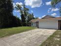 Home with an attached two car garage and traditional architecture at 2798 Beckwith St, Deltona, FL 32738