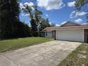 Home with an attached two car garage and traditional architecture at 2798 Beckwith St, Deltona, FL 32738
