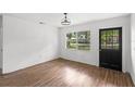 Bright living room features wood-look flooring, fresh white paint and lots of light from the window at 3115 Avenue U Nw, Winter Haven, FL 33881