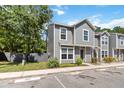 Two-story home featuring gray siding, white trim, and well-maintained landscaping at 4447 Brook Hollow Cir, Winter Springs, FL 32708