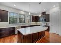 Modern kitchen with an island, stainless appliances, dark wood cabinets and quartz counters at 4562 Lower Park Rd, Orlando, FL 32814
