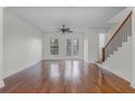 Bright living room with hardwood floors, a ceiling fan, and French doors to a patio at 4562 Lower Park Rd, Orlando, FL 32814