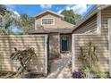 Inviting home entrance surrounded by decorative wooden fence, a gate and landscaped walkway to the front door at 503 Portland Cir, Apopka, FL 32703