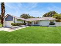 Well-maintained home showcasing a lush green lawn and tidy landscaping at 5130 Sun Palm Dr, Windermere, FL 34786