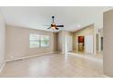 Bright open concept living room featuring tile floors, neutral paint and a ceiling fan at 5130 Sun Palm Dr, Windermere, FL 34786