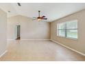 Bright living room with high ceilings, neutral paint, tan tile floors and a ceiling fan at 5130 Sun Palm Dr, Windermere, FL 34786