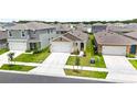 This is an aerial view of a well-maintained neighborhood on a sunny day at 7112 Mottled Duck Dr, Harmony, FL 34773