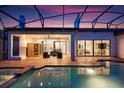 Outdoor pool and patio area with cozy seating, sauna and sliding doors to indoor living spaces at 7733 Pointe Venezia Dr, Orlando, FL 32836