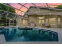 Enclosed pool area with a hot tub, lounge seating and a screened enclosure at 871 Paddington Ter, Lake Mary, FL 32746