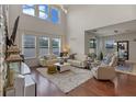 The expansive living room boasts high ceilings, natural light, hardwood floors, and modern furnishings at 9025 Horizon Pointe Trl, Windermere, FL 34786