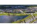 Community aerial view with a pond, showcasing the neighborhood layout and nearby amenities at 9115 Longship Aly, Orlando, FL 32832