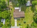 Aerial view of the property highlighting the house, gardens, and surrounding landscape at 1008 Bay Ave, Lake Wales, FL 33859