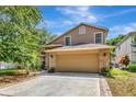 Charming two-story home with a stone-accented front, a two-car garage, and a well-manicured lawn at 1039 Eagles Forrest Dr, Apopka, FL 32712