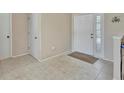 Bright foyer featuring tile flooring, a white front door with decorative glass, and neutral wall paint at 1039 Eagles Forrest Dr, Apopka, FL 32712