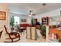 Open-concept living room featuring bright natural light, a ceiling fan, and ceramic tile flooring at 1128 Travertine Ter, Sanford, FL 32771