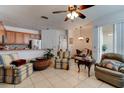 Bright living room with ceramic tile flooring, ceiling fan and sliding glass door to patio at 1128 Travertine Ter, Sanford, FL 32771