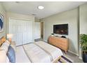 Cozy bedroom with carpet, a TV, a double closet, and neutral tones at 13108 Long Pine Trl, Clermont, FL 34711
