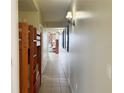 Long hallway with bunkbeds, wall sconces, and view into the living room at 13427 Blue Heron Dr # 2-1401, Orlando, FL 32821