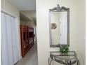 Hallway with bunk beds, decorative mirror, and entry door at 13427 Blue Heron Dr # 2-1401, Orlando, FL 32821