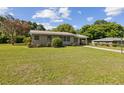 Charming single-story home with a well-manicured lawn and brick facade on a sunny day at 146 Mills Rd, Deland, FL 32724