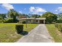 View of a single story home with a brick facade and long driveway at 146 Mills Rd, Deland, FL 32724