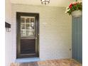 Front door with a brick exterior, brick pavers, and flower pot at 1639 Choctaw Trl, Maitland, FL 32751